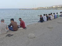 Migrants from Syria, sitting in Kos harbor, as awaiting for the boats to the main land, on September 7, 2015. The head of the European Union...