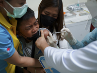 A Thai child receives a dose of Pfizer vaccine for children during a COVID-19 vaccination drive for children aged between five and 11 at the...