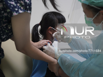 A Thai child receives a dose of Pfizer vaccine for children during a COVID-19 vaccination drive for children aged between five and 11 at the...