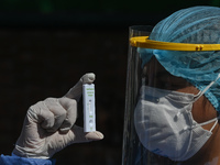 A member of the medical staff wearing full PPE suit holds a negative Covid-19 Antigen test.
On Monday, January 31, 2022, in 
San Cristobal d...