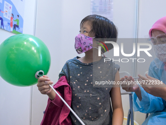 A girl receives a dose of Covid-19 vaccine in Kuala Lumpur, Malaysia on February 3, 2022. Malaysia starts the immunisation programme for kid...