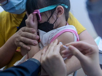 A girl accompanied by his father receives a dose of Covid-19 vaccine in Kuala Lumpur, Malaysia on February 3, 2022. Malaysia starts the immu...