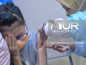 A girl reacts as she receives a dose of Covid-19 vaccine in Kuala Lumpur, Malaysia on February 3, 2022. Malaysia starts the immunisation pro...