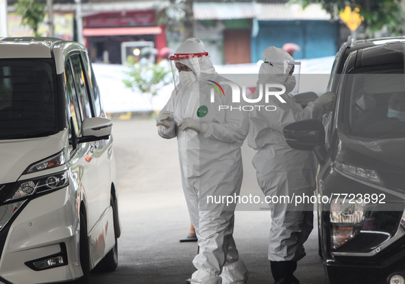 A Medical worker collect a Covid-19 test at a drive-thru COVID-19 testing site in Bogor, West Java, Indonesia on February 4, 2022, as Indone...