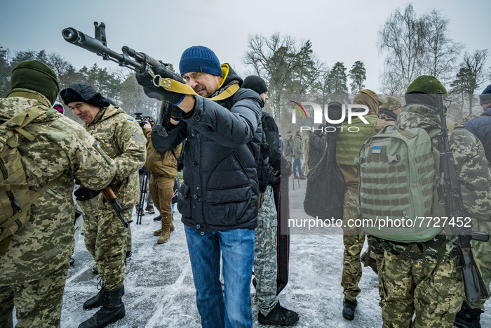 Civilian volunteer of the 112th Territorial Defense Brigade of Kiev points with his  rifle during a military training for civilians in the o...