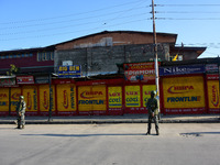 Indian forces stand before the closed shops during Covid-19 lockdown in Srinagar, Indian Administered Kashmir on 05 February 2022.  (