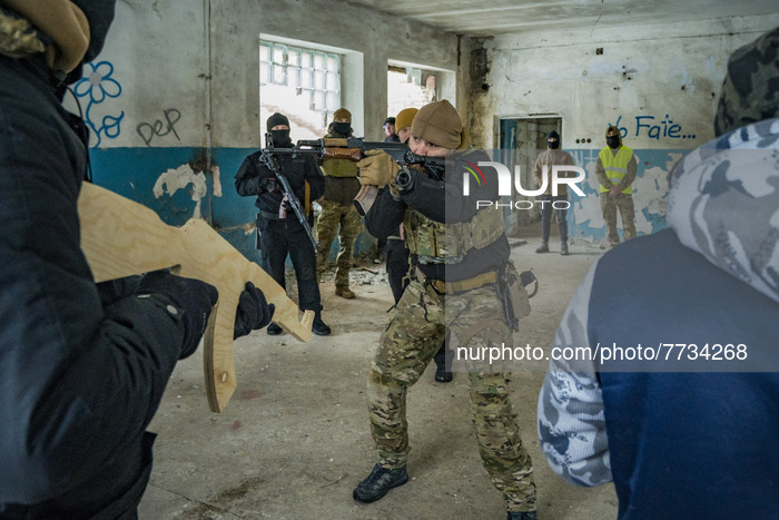 A member of the Azov batallion teachs the right way to point with a rifle to some civilian volunteers for the Territorial Defense Brigades o...