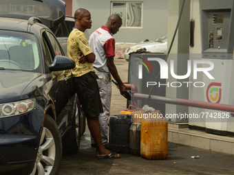 An attendant pumps fuel into jerrycans at FATGBEMS filling station in Lagos, Nigeria, 08 February 2022. Fuel scarcity has hit Lagos and othe...