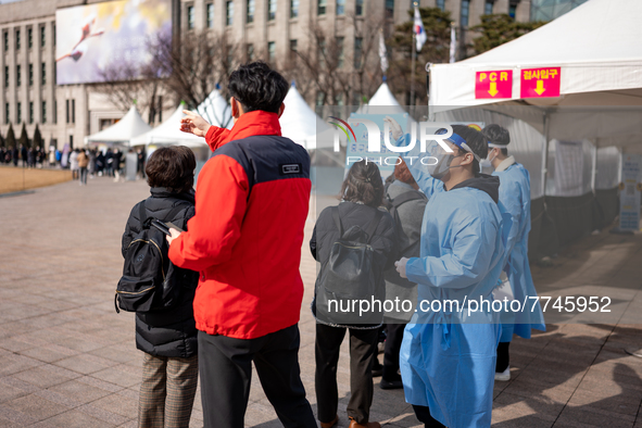 People wait in line at a COVID-19 testing facility at outside of the Seoul City Hall on February 9, 2022 in Seoul, South Korea. South Koreas...