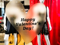 Happy Valentine's Day advertising is seen in a window of a lingerie shop inside Galeria Krakowska shopping mall in Krakow, Poland. February...