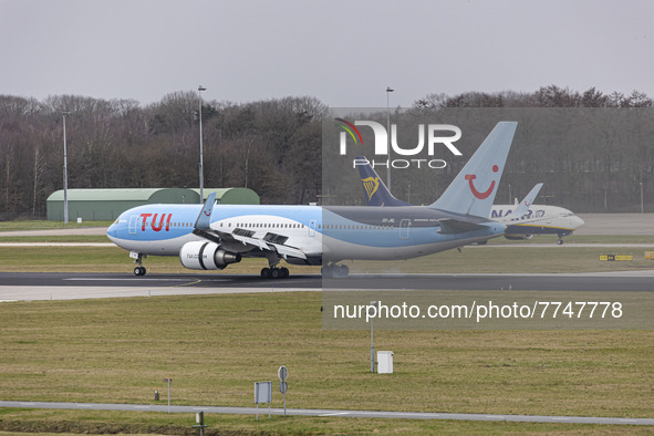 The TUI aircraft is using reverse thrusters to brake down while is passing in front of a Ryanair Boeing 737-800. TUI Airlines Belgium Boeing...