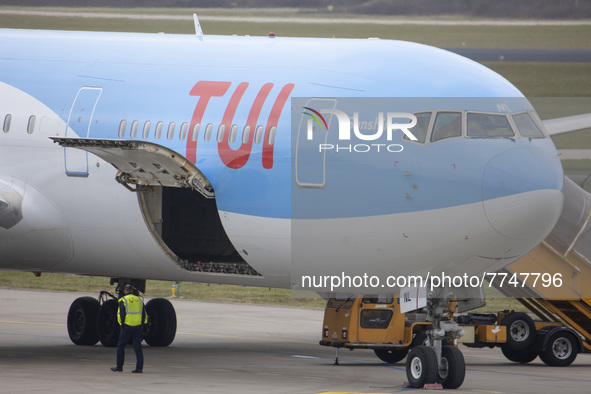 The Cargo door open under the TUI logo. TUI Airlines Belgium Boeing 767-300ER aircraft as seen on final approach flying, landing on the runw...