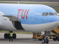 The Cargo door open under the TUI logo. TUI Airlines Belgium Boeing 767-300ER aircraft as seen on final approach flying, landing on the runw...