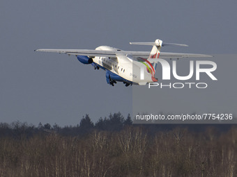 The Dornier jet as seen flying after takeoff. British Airways Dornier Do-328JET-300 aircraft as seen in Eindhoven airport EIN during the tax...