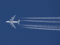 Qatar Airways Airbus A380 double decker aircraft overfly at 40.000 feet in the blue sky during a sunny day over Europe, performing a flight...