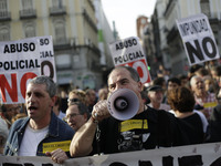 Protestors shout slogans during a protest against police repression in Madrid, Spain, Monday, April, 7th, 2014. A group of associations have...