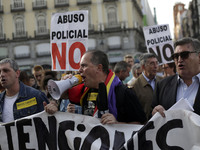 Protestors shout slogans during a protest against police repression in Madrid, Spain, Monday, April, 7th, 2014. A group of associations have...