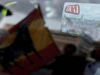 SPAIN, Madrid:a taxi driver holding a Spanish flag during the taxi drivers protests front the Ministry of Public Works in Madrid on Septembe...