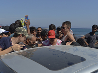 Every food distribution by volunteers to refugees looks like a battle, in Kos, on September 10, 2015. The head of the European Union's execu...