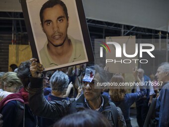 A man showing off pictures of his son, who died at sea to escape from Syria. Milan September 11, 2015. (