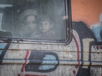 Migrants look through a window onboard a train for Serbia after crossing the Macedonian-Greek border near Gevgelija on September 12, 2015. A...
