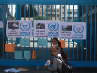 Palestinians take part in a protest against the decision made by the United Nations Relief and Works Agency (UNRWA) to reduce food aid deliv...