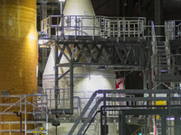 The nose cone of the solid rocket boosters for Artemis 1 project above a work platform 200' above the ground  in the Vehicle Assembly Buildi...