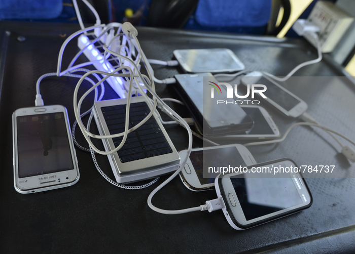 Migrants charge their phones during the bus trip from Preshevo to Belgrade.
Belgrade, Serbia, on September 15, 2015 (Photo by Artur Widak/Nu...