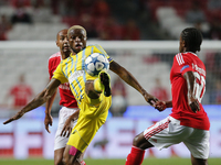 Astana's forward Junior Kabananga  (C) vies for the ball with Benfica's defender Luisao (L) and Benfica's defender Nelson Semedo  (R)  durin...