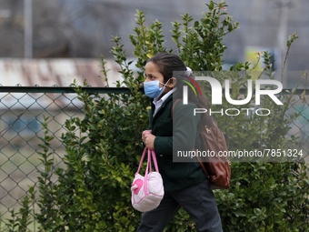 A Girl students walks in the premises of a school in Baramulla Jammu and Kashmir India on 02 March 2022. An employee checks the temperature...