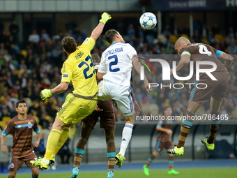 Goalkeeper Oleksandr Rybka of FC Dinamo, left, fight for the ball during the first match of the Champions League between FC Dynamo Kyiv and...