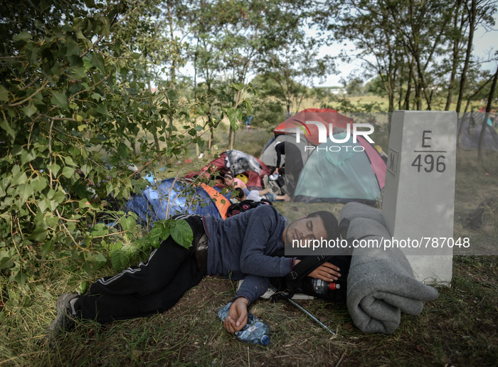 A migrant sleep near Hungarian side near the razor wire fence at the Serbia-Hungary border in Horgos, on September 16, 2015. UN Secretary-Ge...