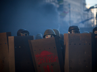 Anti-government protesters clash with riot police in front of the Parliament in central Kiev on February 18, 2014. Five people died on Febru...