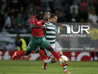 Lokomotiv's midfielder Oumar Niasse (L) vies for the ball with Sporting's defender Joao Pereira (R)  during the UEFA Europa League  football...