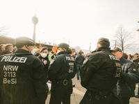 polices are seen observing the crowd of protesters during the weekly anti vaccination demo in Duesseldorf, Germany on March 12, 2022 (Photo...