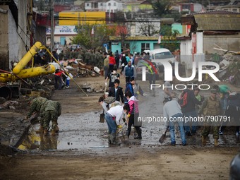 Local residents clean the debris left by the tsunami that ensued an 8.3 quake that left 12 people dead and five more missing, in Coquimbo, 4...