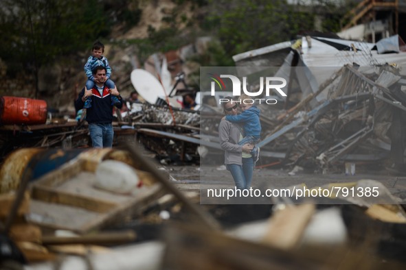 Residents walk between debris caused by the sea in the port of Coquimbo, some 445 km north of Santiago, during the eve's earthquake on Septe...