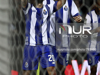 Porto's Portuguese midfielder André André (L) celebrates after scoring a goal during the Premier League 2015/16 match between FC Porto and S...