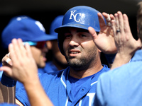 Kansas City Royals' Kendrys Morales is congratulated after scoring a run on a single hit by Alex Rios in the first inning of a baseball game...