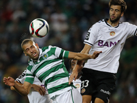 Sporting's forward Islam Slimani (L) heads for the ball with Nacional's defender Rui Correia (R)  during the Portuguese League  football mat...