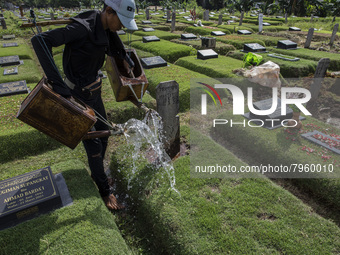 Officers clean the COVID-19 graveyard in Srengsesngsawah, South Jakata, Jakarta, Indonesia. Towards Ramadan, officers clean the graves, so t...