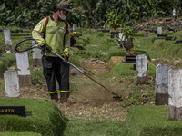 Officers clean the COVID-19 graveyard in Srengsesngsawah, South Jakata, Jakarta, Indonesia. Towards Ramadan, officers clean the graves, so t...