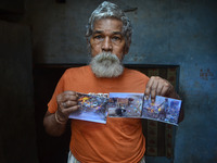 Devanand Shukla,aged 73 yrs. ,shows photographs of his work for cleaning the river Ganges,in Allahabad on September 22,2015.Devanand Shukla,...