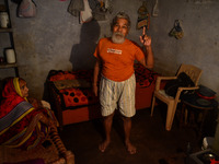 Devanand Shukla,aged 73 yrs.with his wife (L) who is suffering from phyleria disease,talks during a conversation about  his work for cleanin...