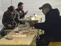 A mobile phone charging point set up by volunteers, as thousands of migrants awaiting to enter to the transfer camp in Opatovac near the bor...