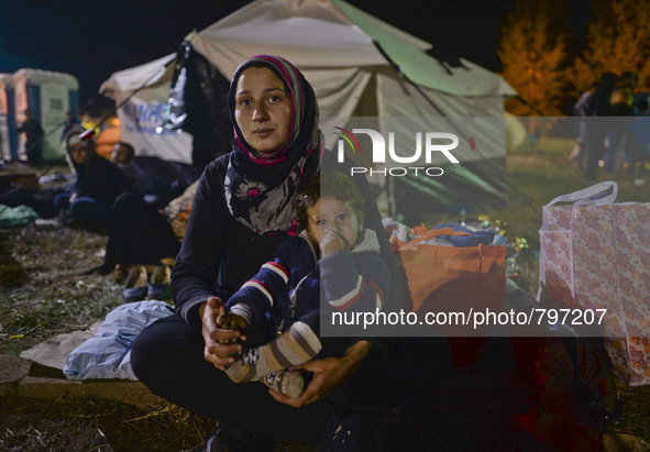 Naja from Syria with her Mum, as houndreds of other migrants awaiting to enter to the transfer camp in Opatovac near the border crossing poi...