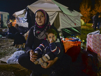 Naja from Syria with her Mum, as houndreds of other migrants awaiting to enter to the transfer camp in Opatovac near the border crossing poi...