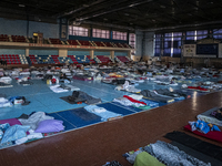 In the halls and rooms of the IOHICTB Sporting Complex, refugees from villages and towns attacked by Russian forces have set up a makeshift...