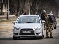 Soldiers carry out thorough checks on all their vehicles and passengers at various checkpoints in the Kiev region. The capital of Ukraine, K...