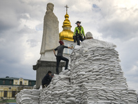 Volunteers cover a monument of the Princess Olga, Apostle Andrew, Cyril and Methodius of sand bags for protection as Russia's invasion of Uk...
